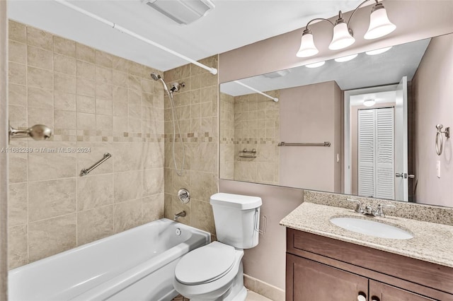 full bathroom featuring vanity, toilet, and tiled shower / bath