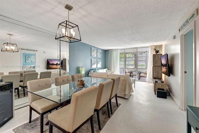 dining area with a chandelier and a textured ceiling