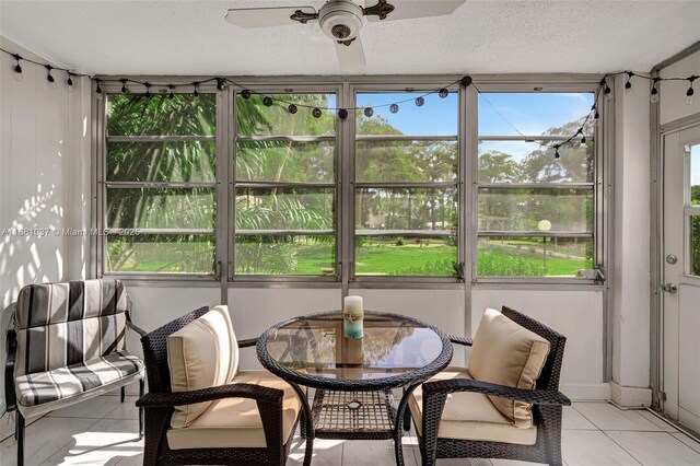 sunroom / solarium featuring ceiling fan