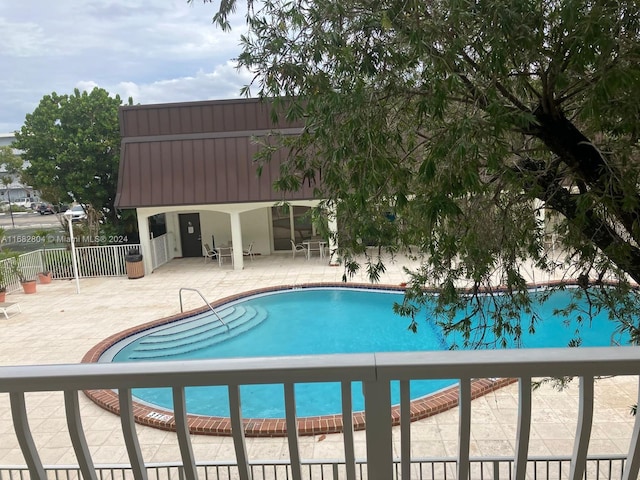 view of swimming pool featuring a patio area