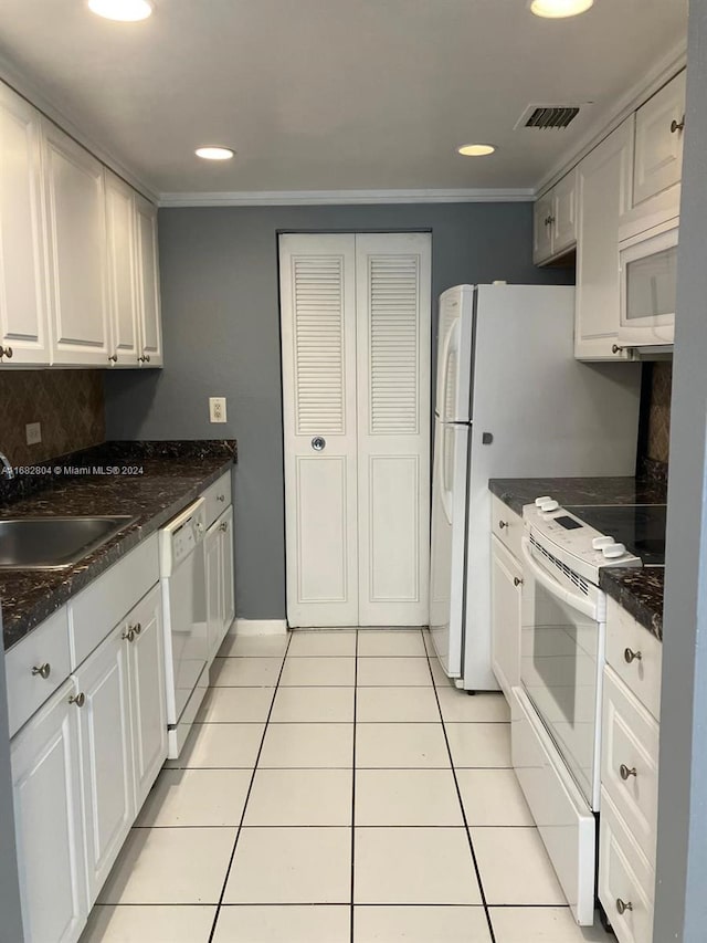 kitchen with white appliances, crown molding, sink, and white cabinets