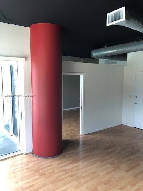 spare room featuring light hardwood / wood-style floors and plenty of natural light