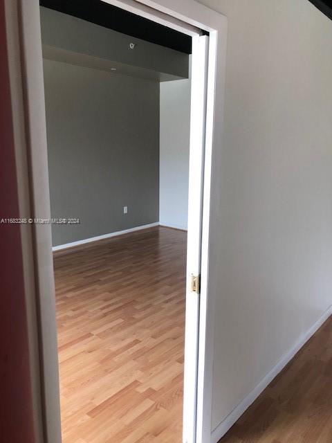 corridor featuring hardwood / wood-style floors