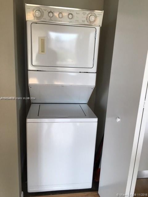 clothes washing area featuring stacked washer / drying machine