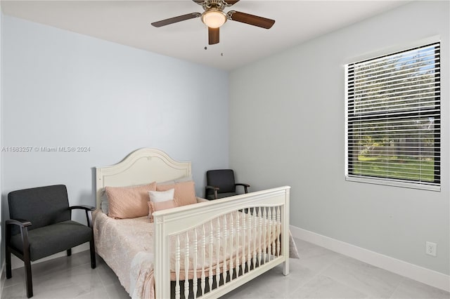 bedroom featuring multiple windows and ceiling fan