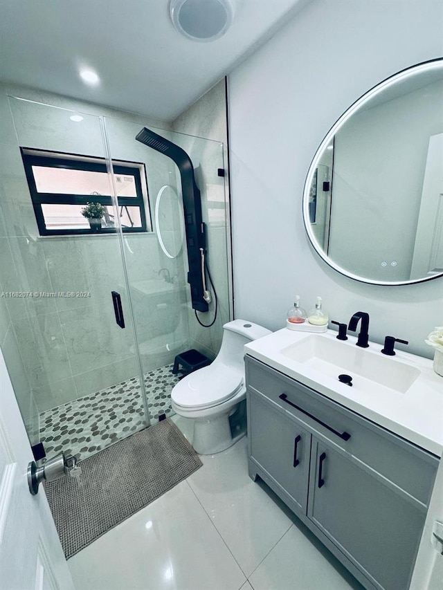 bathroom with vanity, walk in shower, tile patterned floors, and toilet