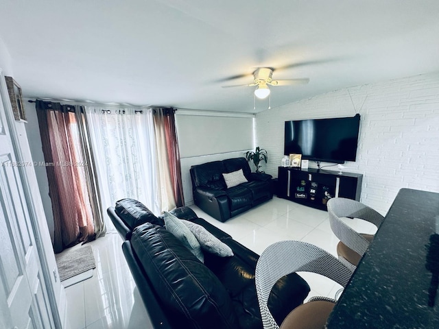 tiled living room featuring brick wall and ceiling fan