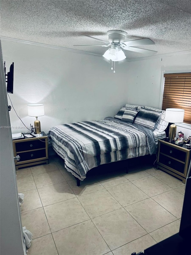 tiled bedroom featuring ceiling fan and a textured ceiling