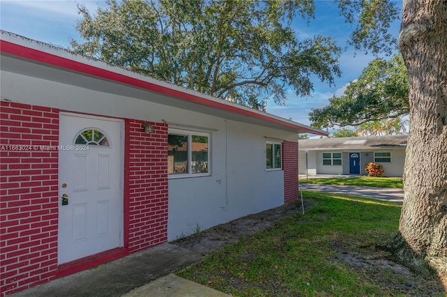 view of property exterior with a yard