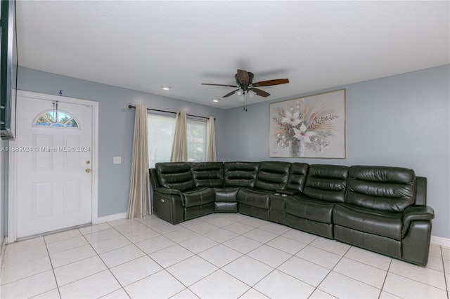 bedroom with ceiling fan, a textured ceiling, and light tile patterned floors