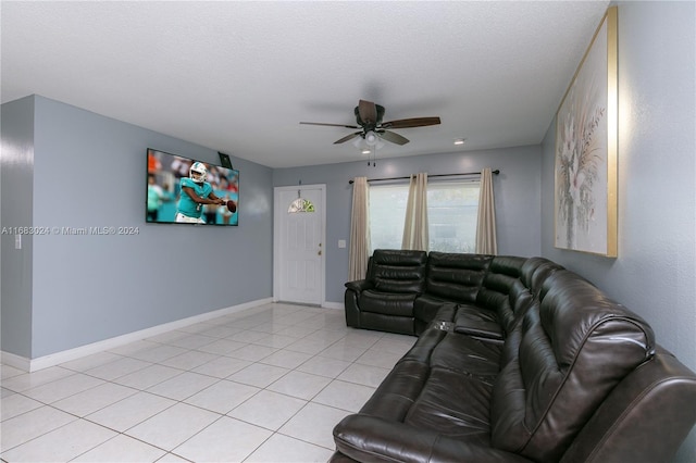 living room with ceiling fan, a textured ceiling, and light tile patterned floors