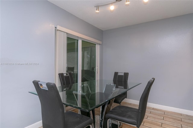 2510 SW Natura Blvd, Deerfield Beach, FL 33441 - dining room with light wood finished floors and rail lighting