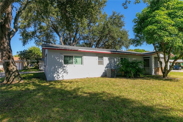 2510 SW Natura Blvd, Deerfield Beach, FL 33441 - back of property featuring a lawn and stucco siding