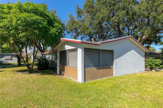 view of side of home featuring a lawn