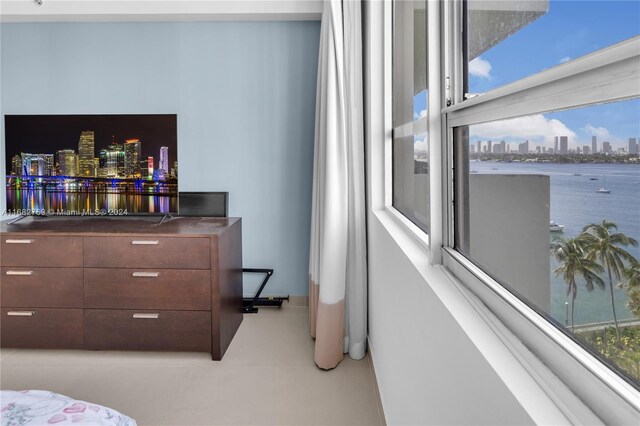 bedroom featuring a water view