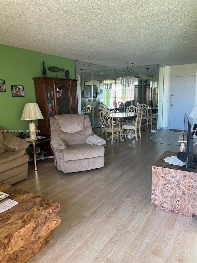 living room with wood-type flooring and a textured ceiling