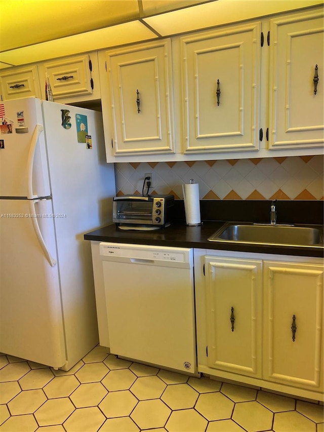 kitchen featuring white appliances, tasteful backsplash, white cabinetry, and sink