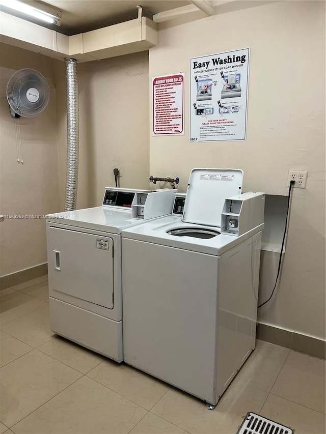 washroom with washing machine and dryer and light tile patterned floors