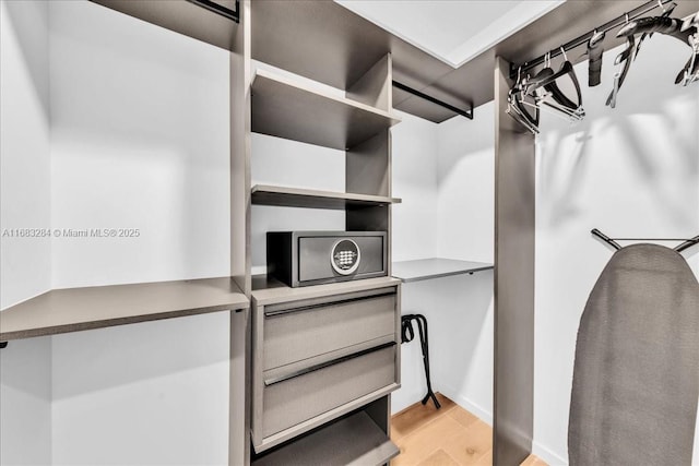 spacious closet with light hardwood / wood-style flooring