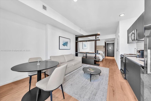 living room with light hardwood / wood-style flooring