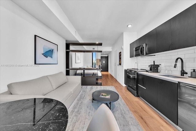 living room featuring light hardwood / wood-style floors and sink