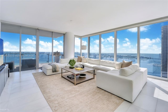 sunroom / solarium featuring a water view