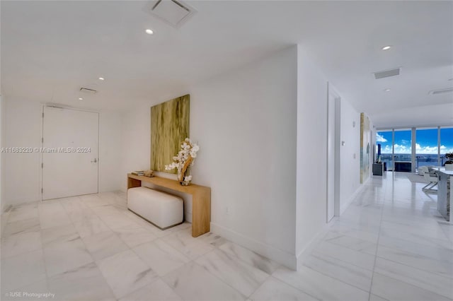 hallway featuring expansive windows