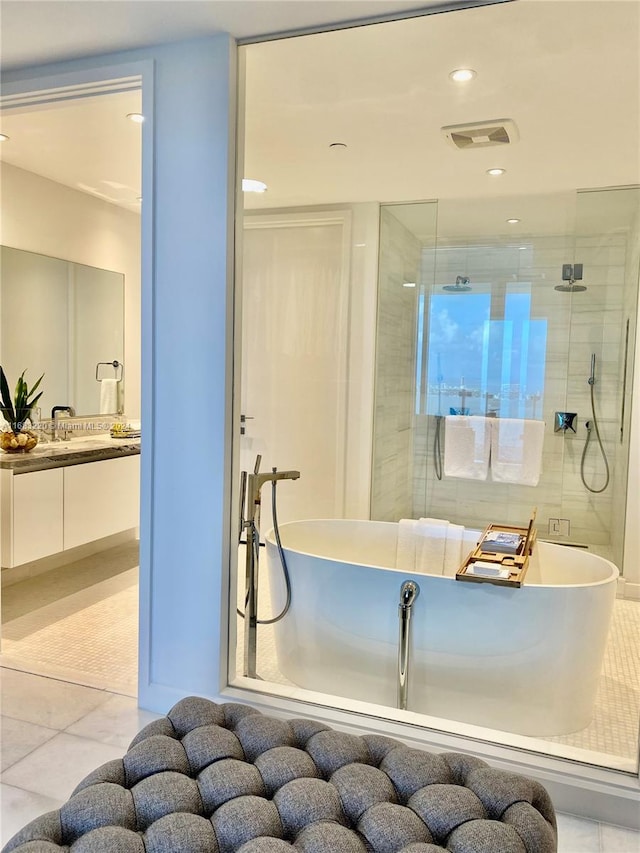 bathroom featuring vanity, independent shower and bath, and tile patterned flooring