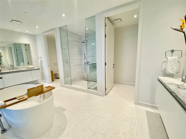 full bathroom with vanity, toilet, shower with separate bathtub, and tile patterned flooring