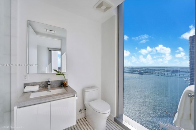 bathroom featuring vanity, a water view, and toilet