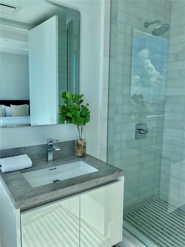 bathroom featuring vanity and a tile shower