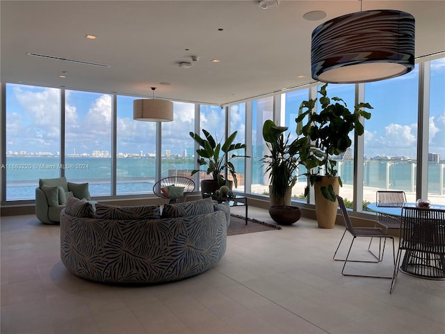 sunroom / solarium featuring plenty of natural light and a water view