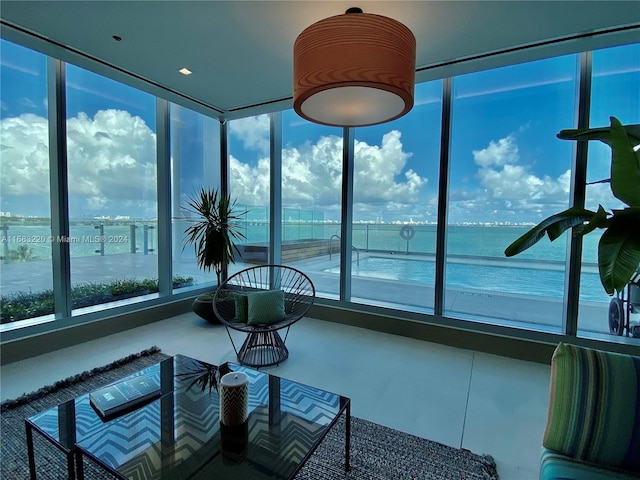 sunroom / solarium with a water view