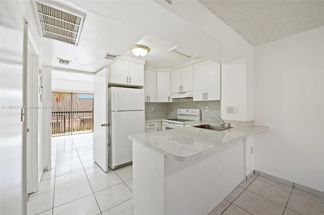 kitchen with white appliances, sink, backsplash, white cabinets, and light tile patterned floors