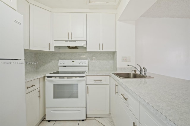 kitchen featuring white appliances, decorative backsplash, sink, and white cabinets