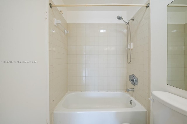 bathroom featuring toilet and tiled shower / bath combo