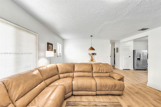 living room with hardwood / wood-style floors and a textured ceiling