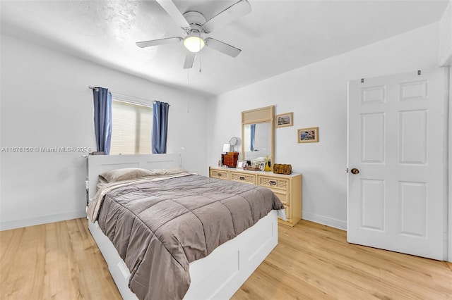 bedroom with ceiling fan and light hardwood / wood-style floors