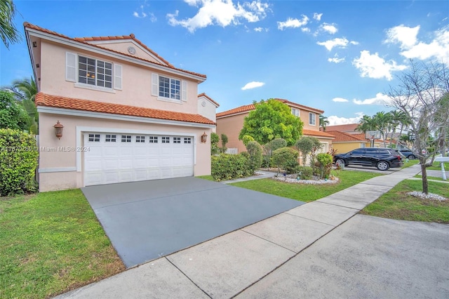 mediterranean / spanish home with a front yard and a garage