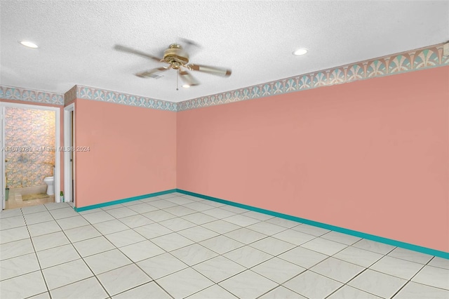 spare room featuring a textured ceiling and ceiling fan