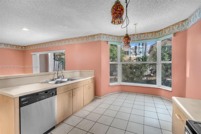 kitchen with sink, decorative light fixtures, stainless steel appliances, and a textured ceiling