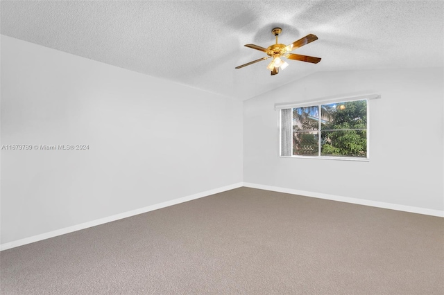 carpeted empty room with lofted ceiling, a textured ceiling, and ceiling fan