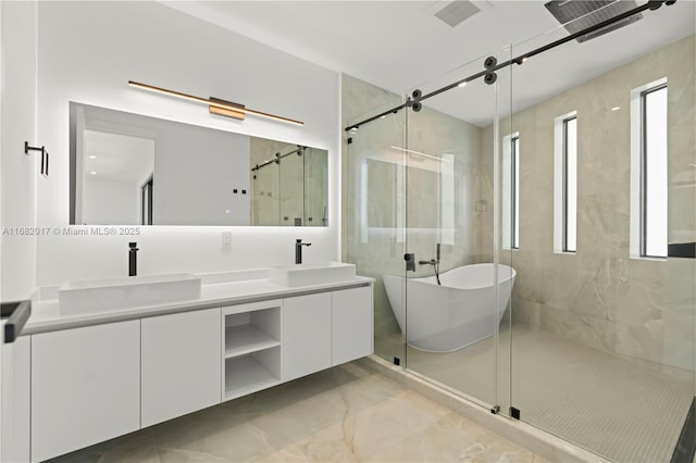 full bath featuring a freestanding tub, a sink, a shower stall, and double vanity