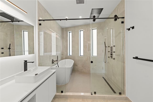 bathroom featuring vanity, shower with separate bathtub, and plenty of natural light