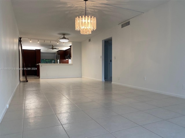 interior space with light tile patterned flooring and ceiling fan with notable chandelier