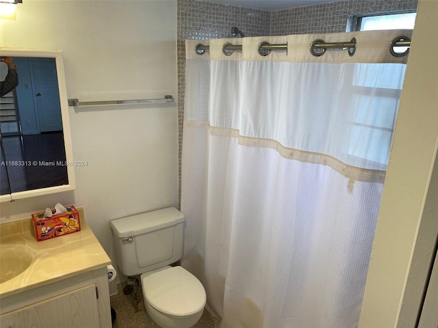 bathroom with vanity, toilet, and a shower with curtain