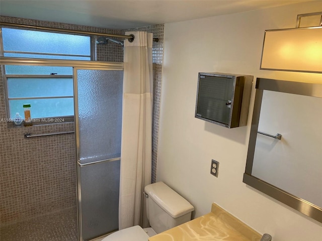 bathroom featuring walk in shower and toilet