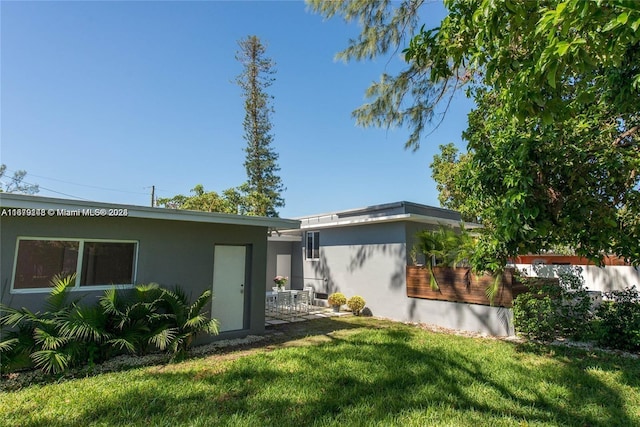 rear view of property with a yard