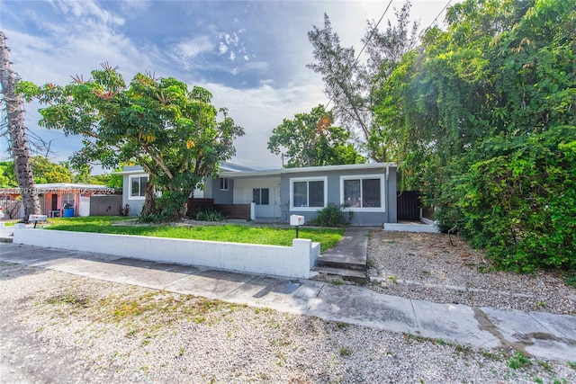 ranch-style house with a front lawn