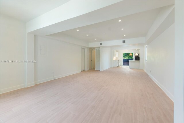 11515 NE 12th Ave, Miami, FL 33161 - unfurnished living room with light wood finished floors and recessed lighting